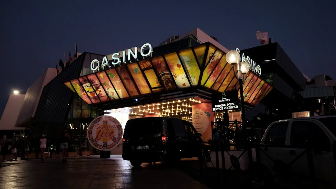 a casino entrance lit up at night with lights