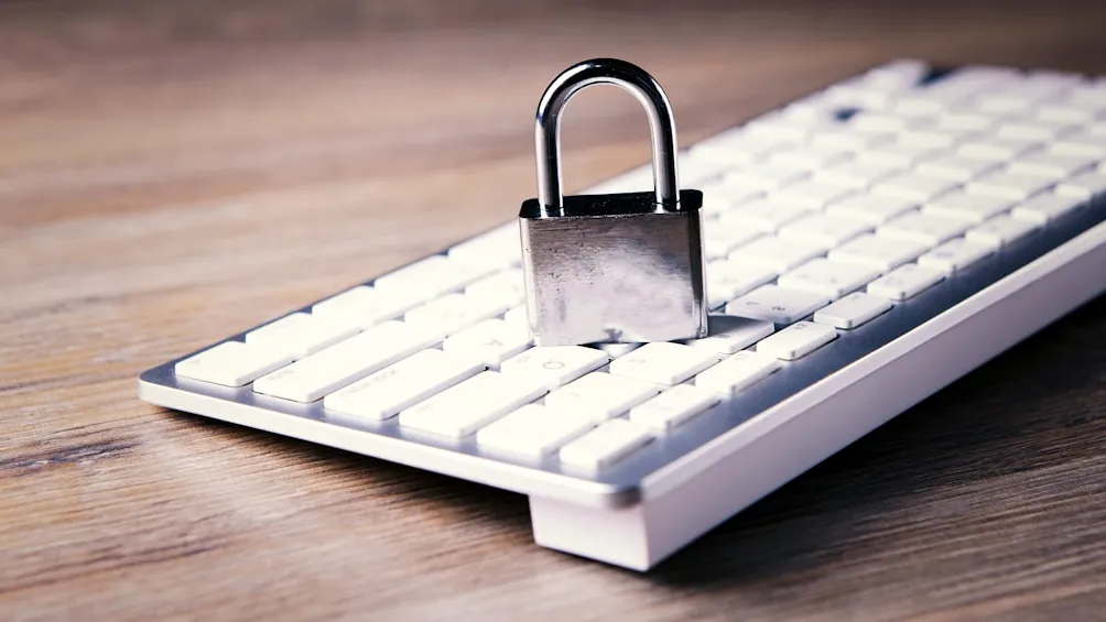 a computer keyboard with a padlock on top of it