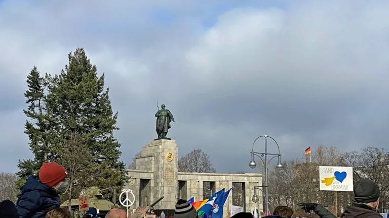 a crowd of people standing around a statue