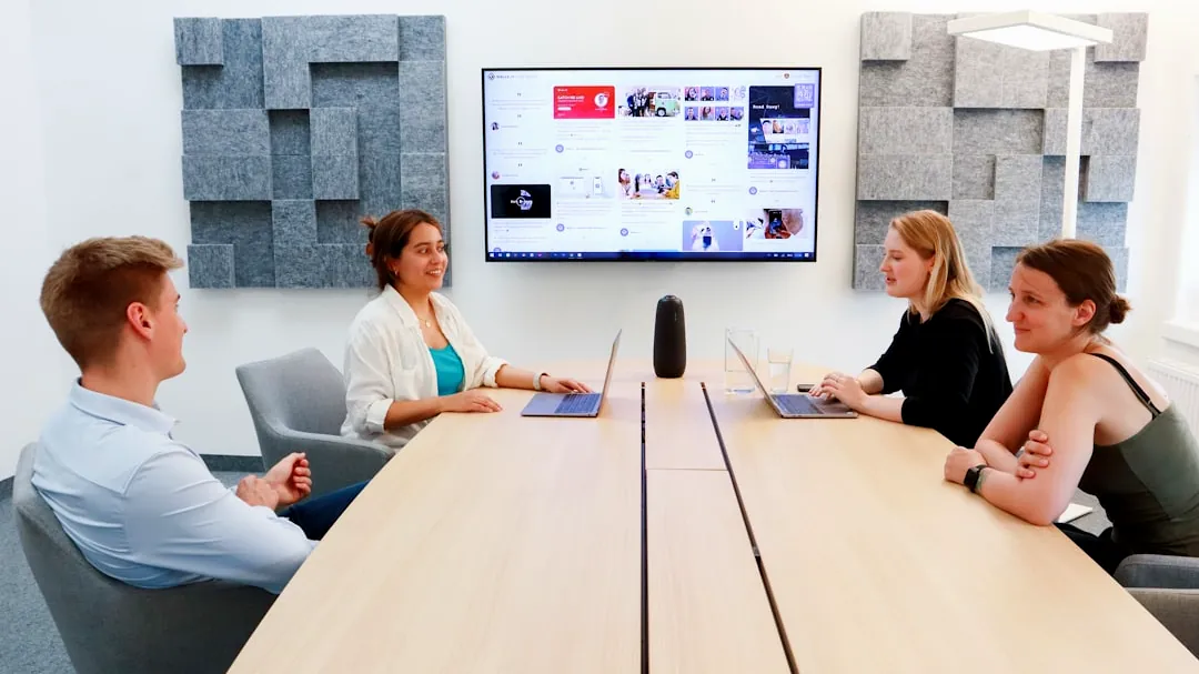 a group of people sitting around a conference table