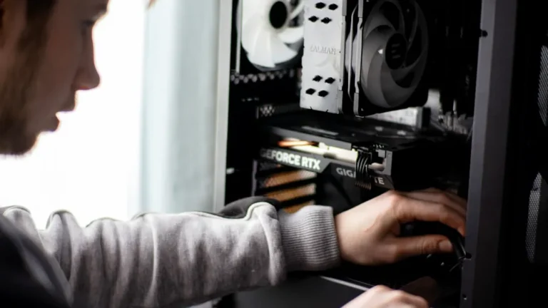 A man is working on a computer in a room