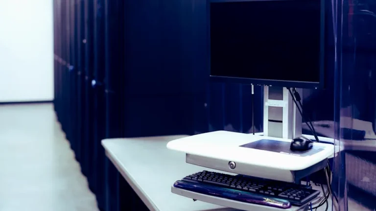 A modern data center featuring a computer setup with monitor and keyboard, emphasizing technology infrastructure.