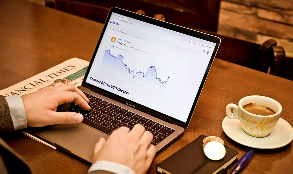 a person using a laptop on a wooden table
