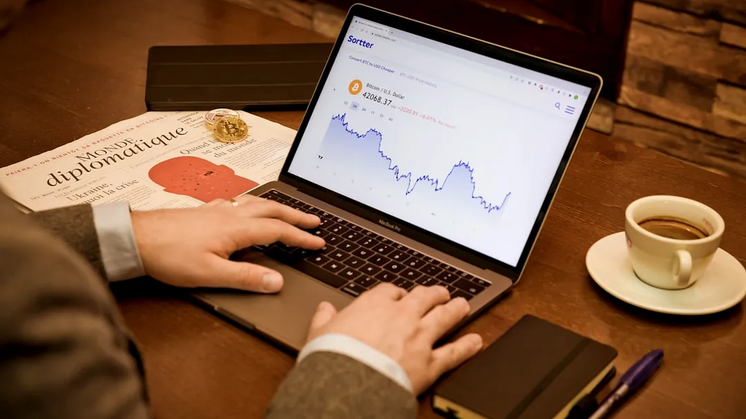 a person using a laptop on a wooden table