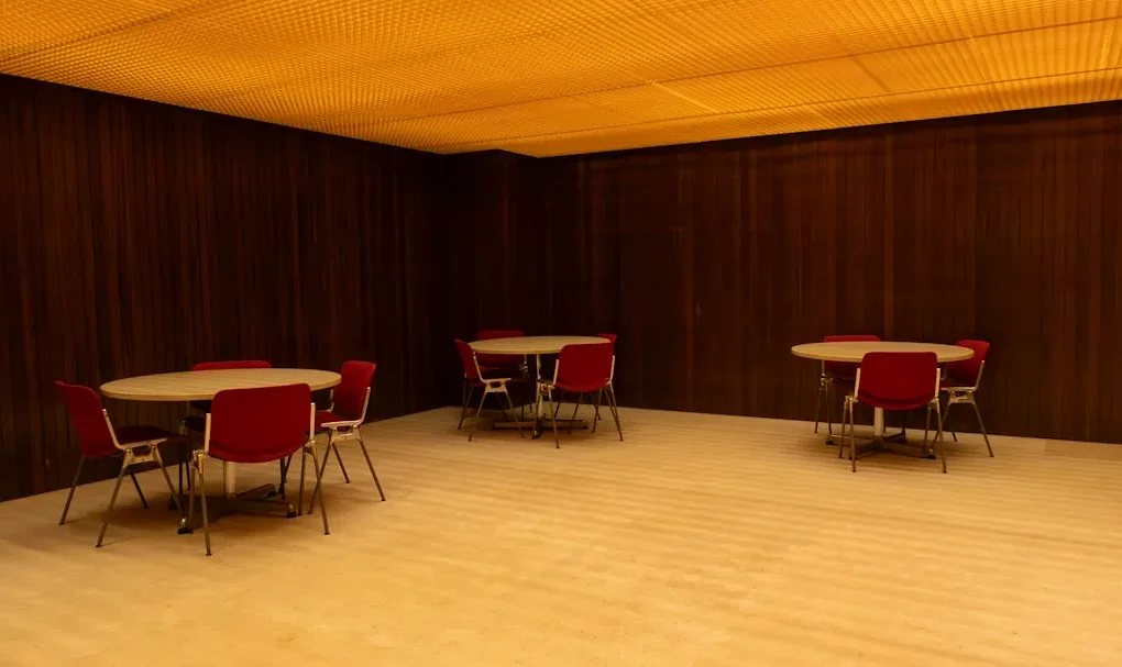 A room with tables and chairs and a ceiling