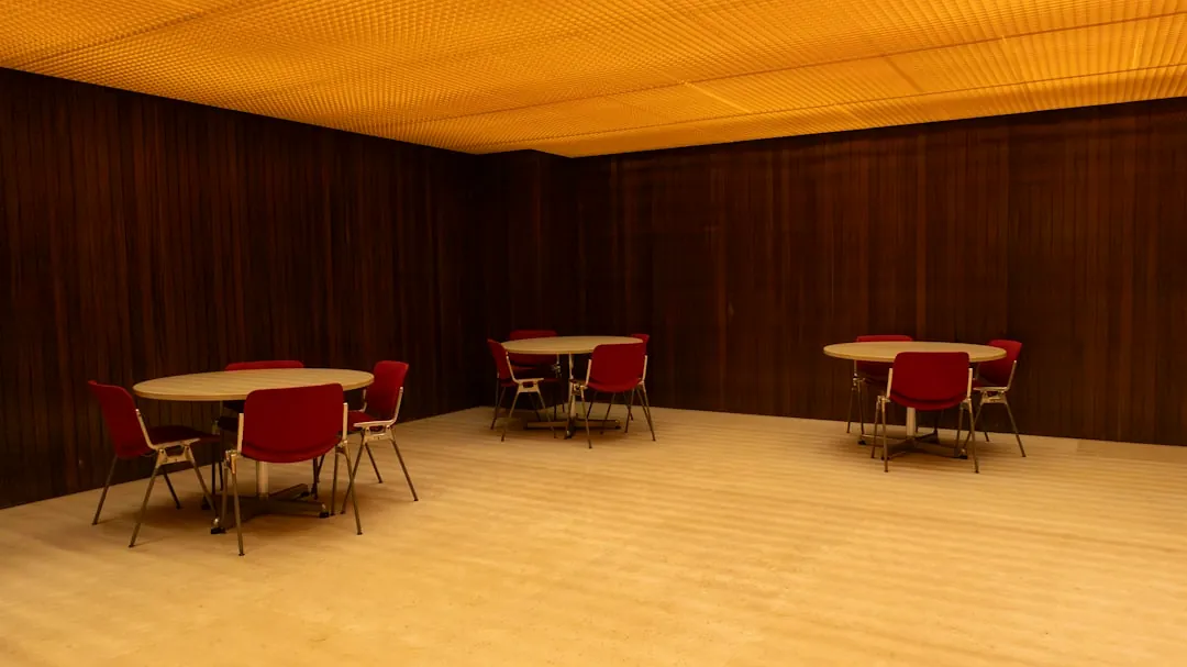 A room with tables and chairs and a ceiling