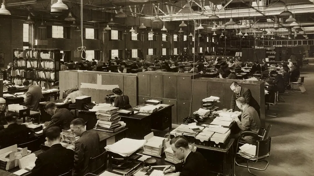 grayscale photo of man and woman sitting on chair