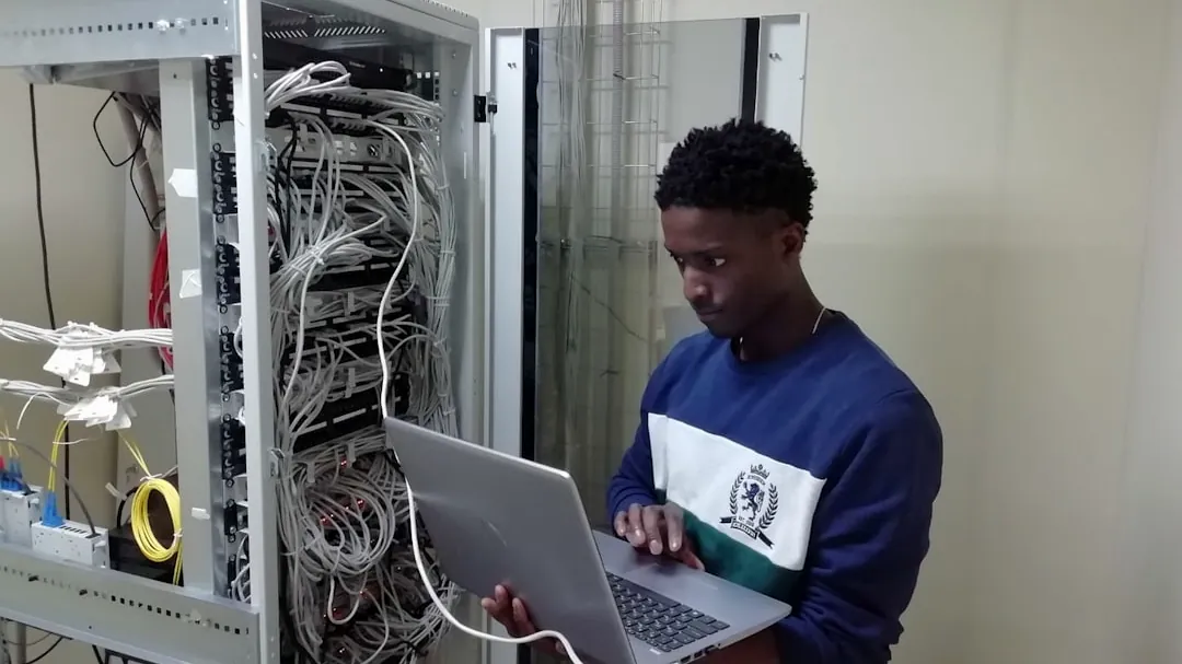 man in blue sweater using silver macbook
