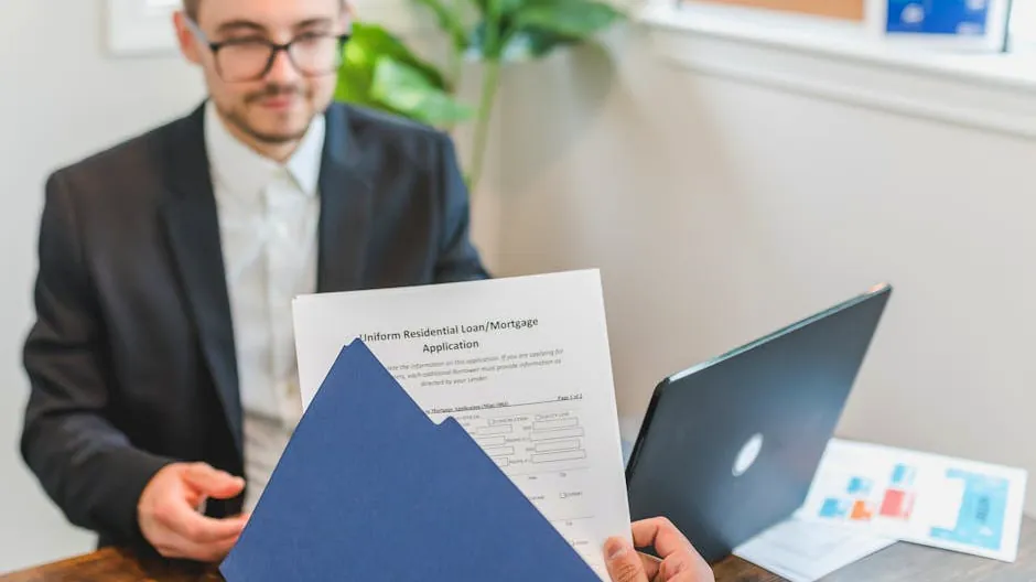 Mortgage broker and client discussing loan application with documents on table.