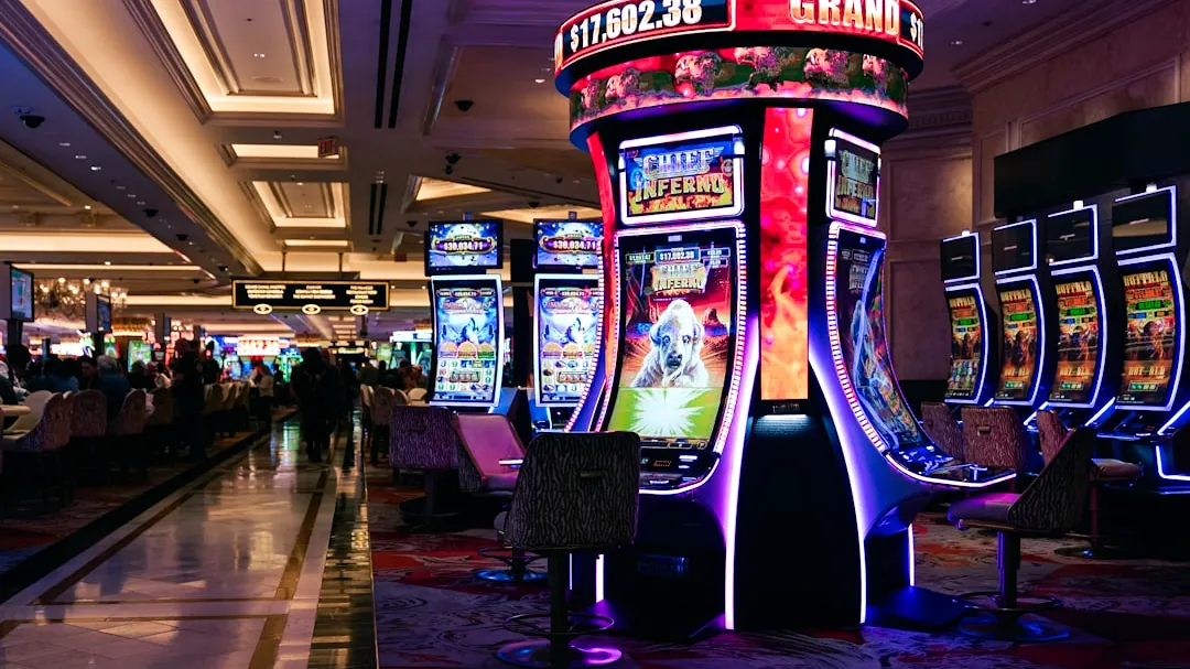 Rows of illuminated slot machines in a casino