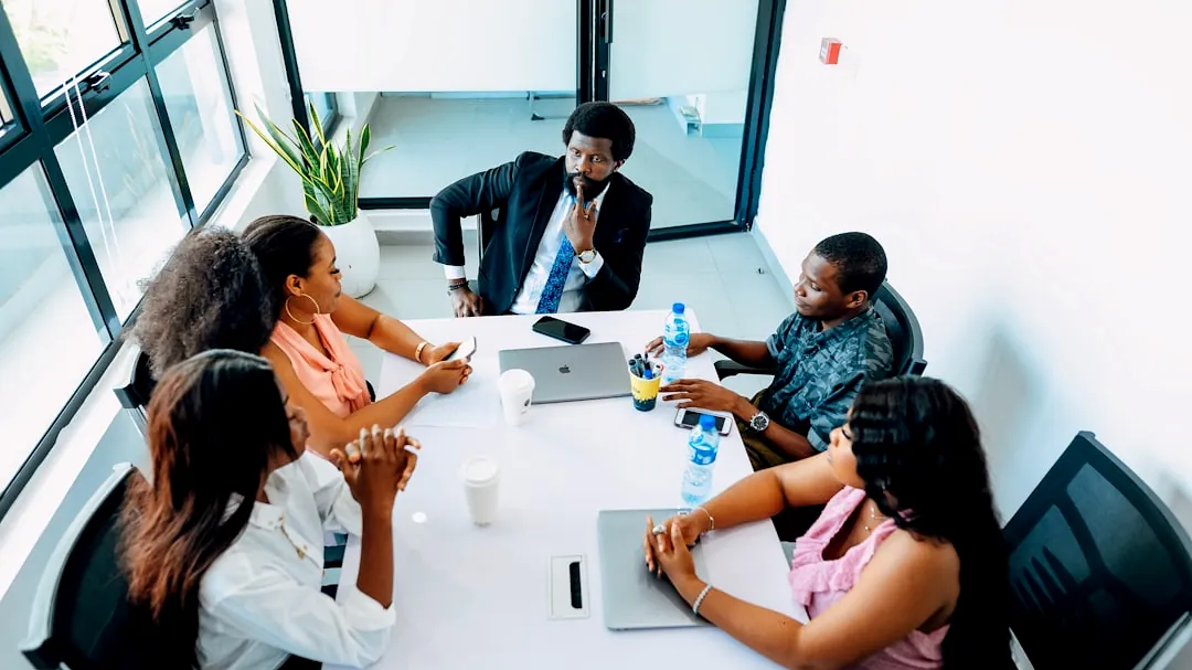 A group of people sitting around a white table