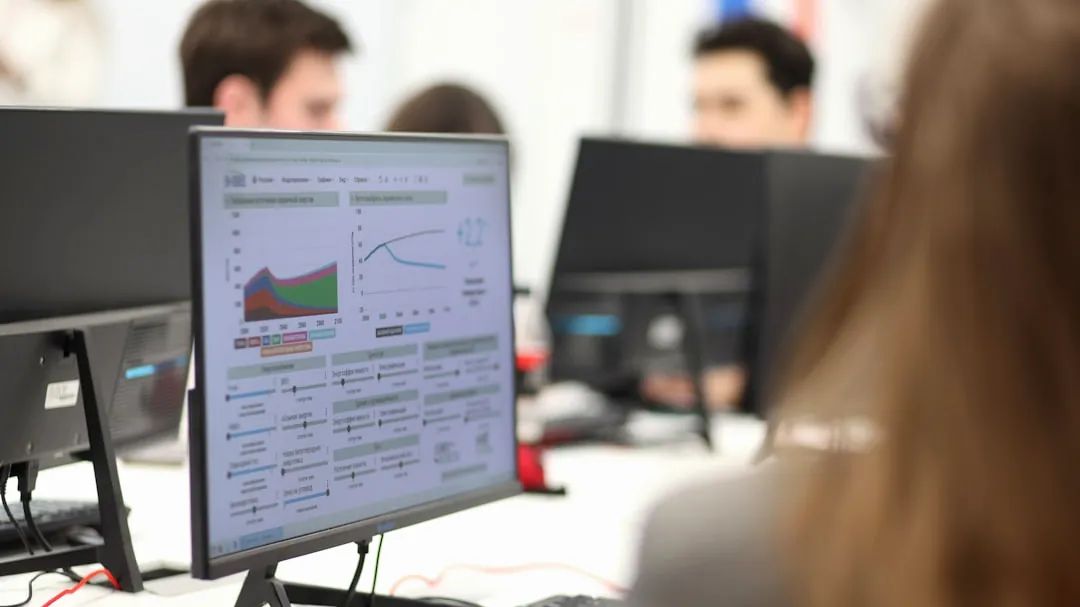 A group of people working on computers in a room