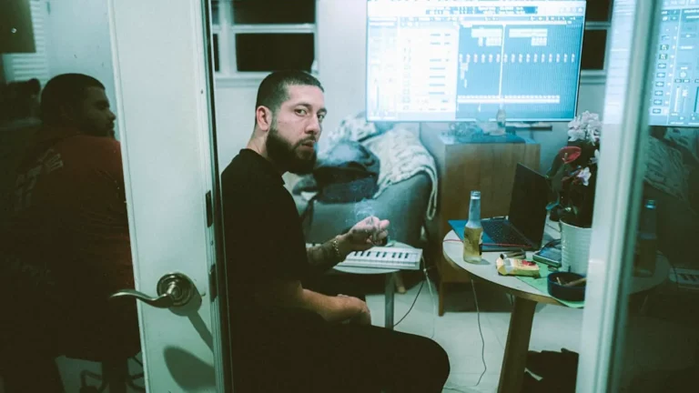 a man sitting in front of a computer monitor