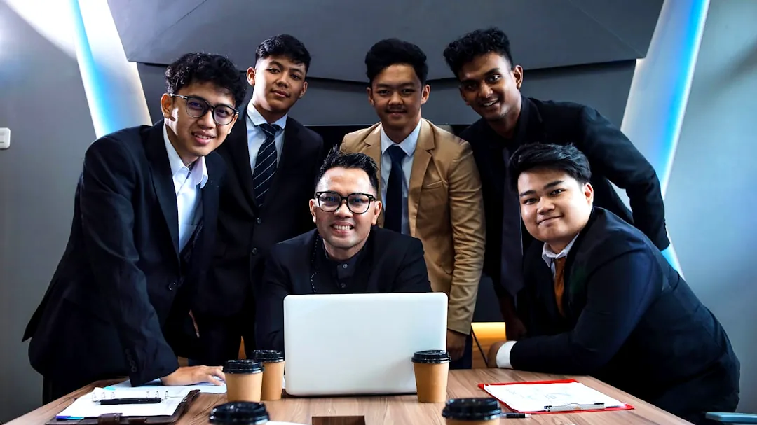 A team of professionals is gathered around a table.
