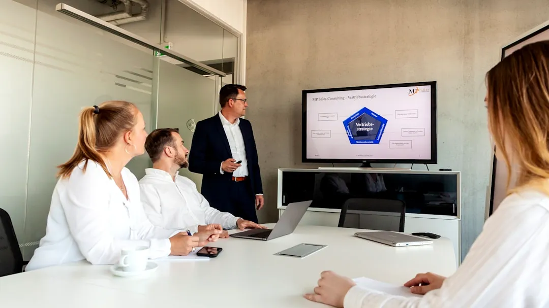 Business meeting with a presenter and colleagues in office.