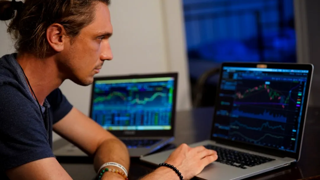 man sitting in front of the MacBook Pro