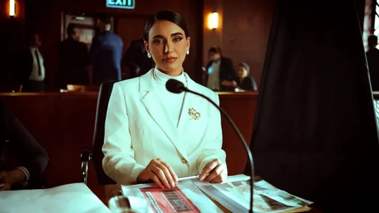 A poised woman in a white suit sits confidently in a courtroom setting, Baghdad.
