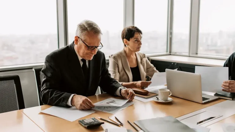 Corporate meeting with professionals discussing documents in a modern office.