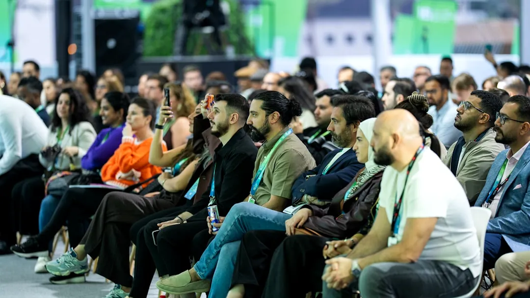 Diverse audience attentively listening at a conference event.