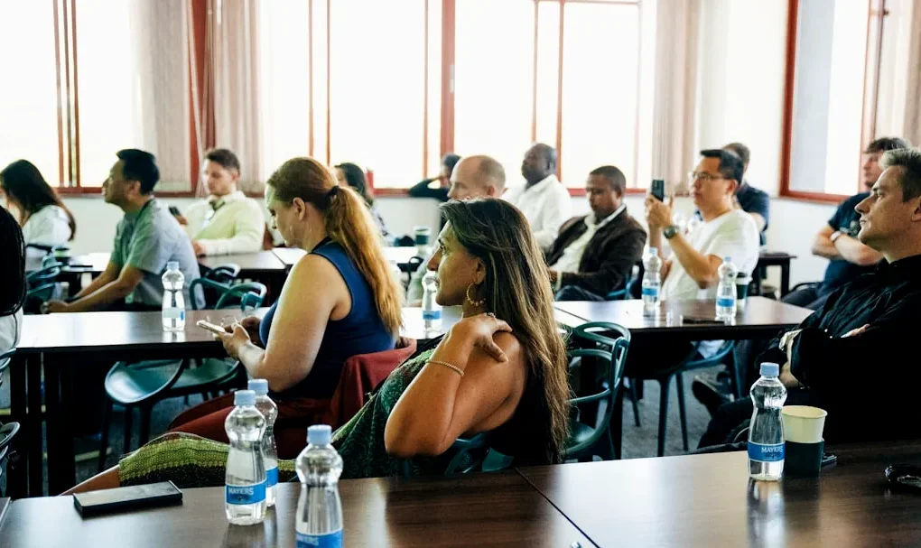 People sitting at tables in a conference room.