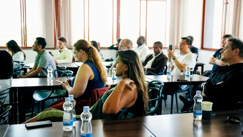 People sitting at tables in a conference room.