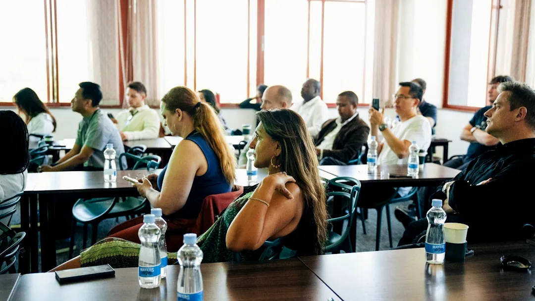 People sitting at tables in a conference room.