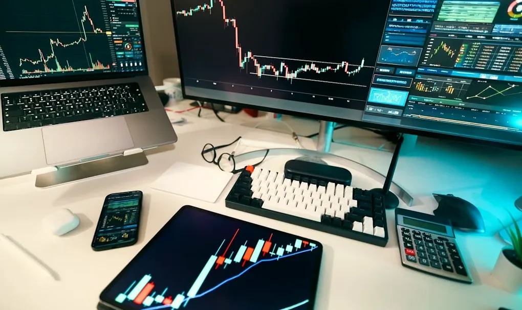 Stock charts are displayed on multiple screens.
